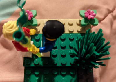 Photograph of a Lego Serious Play student project with human figurine holding a pole.